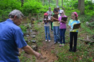 Dr. Dale pointing out some erosion on the path down to the river